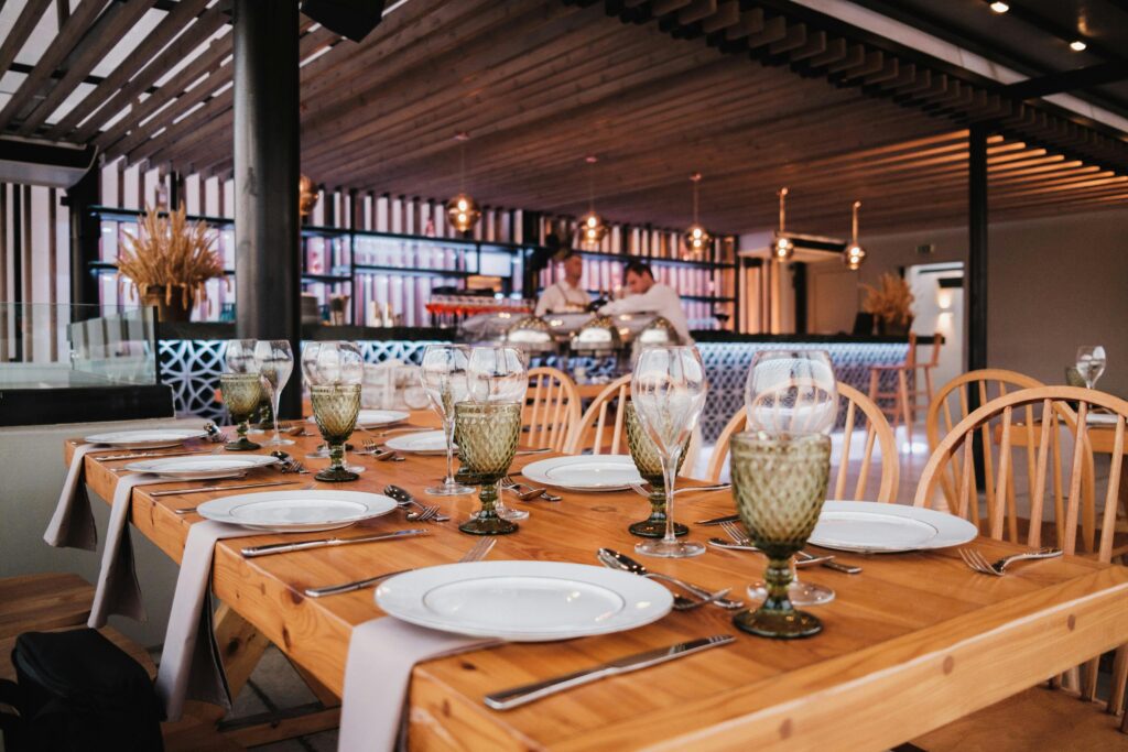 pexels-photo-15189515-15189515 A beautifully set restaurant table with elegant glassware, ready for dining in a stylish interior.